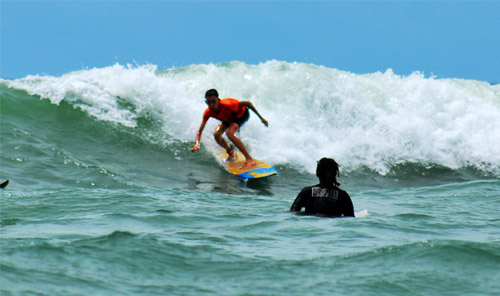 Surfing on the Tanjung Setia Beach, West Lampung, Indonesia
